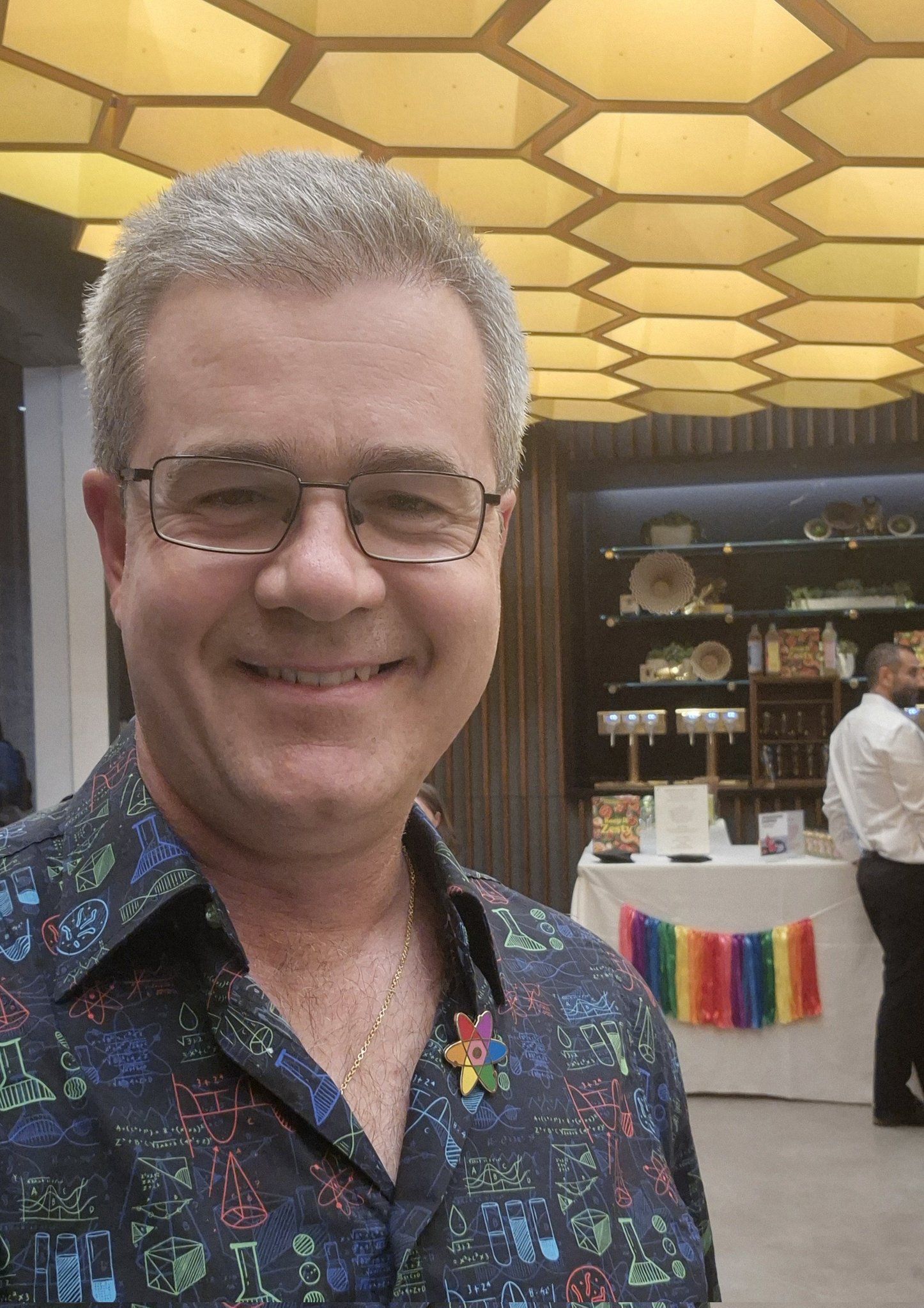 Smiling man near colorful display table
