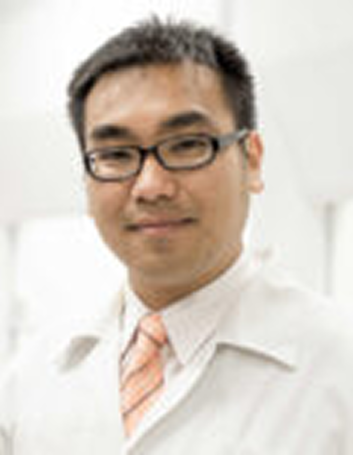 Man in glasses wearing a white lab coat